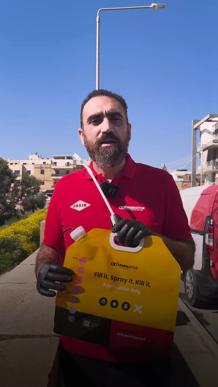 The Exterminator video ad filmed outdoors, holding a refill pack